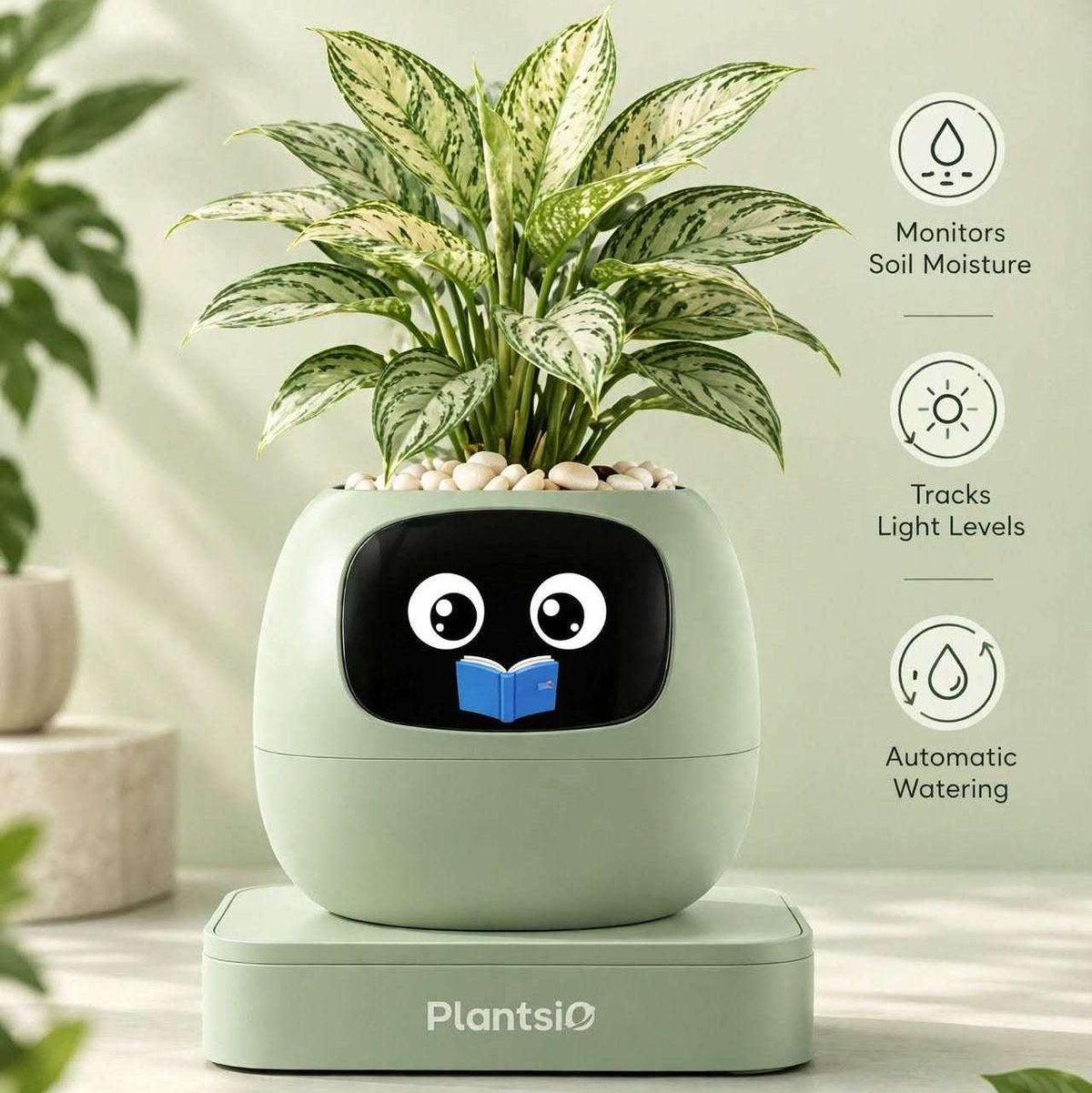 Smart Planter in pale mint green with a glossy black cartoon face, holding a leafy variegated plant and featuring a matching base.